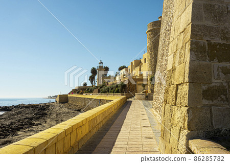 The Mediterranean sea and a path next to the old castle. City Roquetas del Mar. Province of Almeria. Andalusia. Spain. The Mediterranean sea and a path next to the old castle. City Roquetas del Mar. Province of Almeria. Andalusia. Spain. 86285782