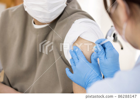 Senior man in a wheelchair vaccinated at a long-term care facility Senior man in a wheelchair vaccinated at a long-term care facility 86288147
