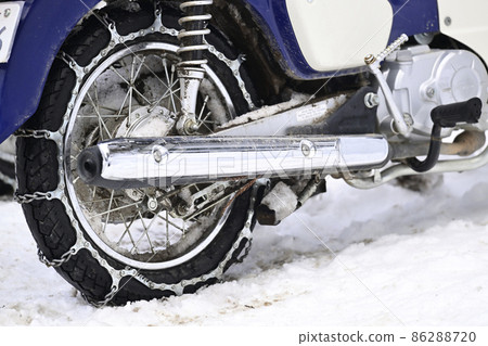 Tire chains wrapped around motorcycle tires 86288720