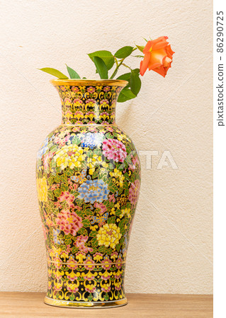 Benjarong Vase with red rose on wooden table. Benjarong Vase with red rose on wooden table. 86290725
