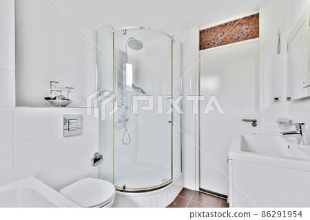 A fascinating bathroom with dark brown tiled floor and a shower A fascinating bathroom with dark brown tiled floor and a shower 86291954