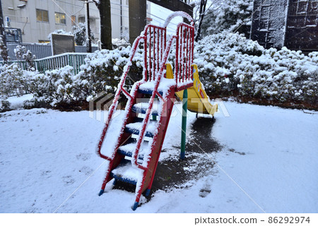 A slide in a park with snow A slide in a park with snow 86292974