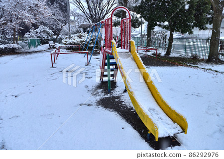 A slide in a park with snow A slide in a park with snow 86292976