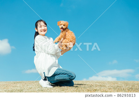 Female playing with her dog (lawn) Female playing with her dog (lawn) 86293813