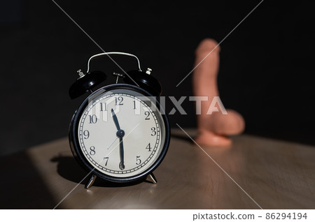Time for carnal pleasures. Alarm clock and dildo made of cyber leather. Naturalistic vibrator for masturbation. 86294194