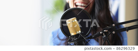 Studio black microphone in background woman sings closeup Studio black microphone in background woman sings closeup 86296329
