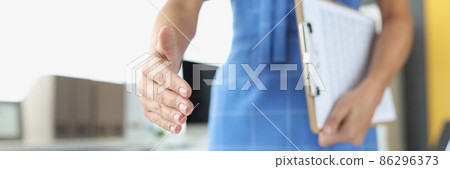 Businesswoman stretches out hand for handshake closeup 86296373