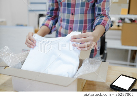Online business owner preparing product to customer. 86297805