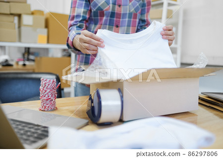 Online business owner preparing product to customer. 86297806