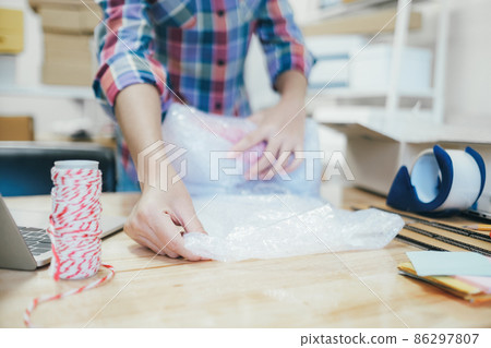 Online business owner preparing product to customer. 86297807
