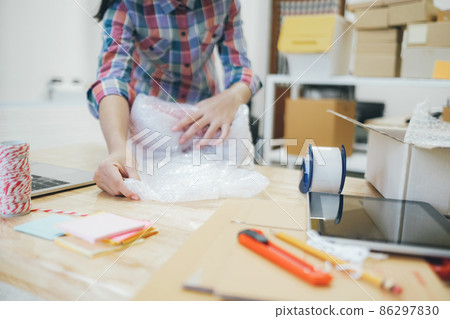 Online business owner preparing product to customer. 86297830