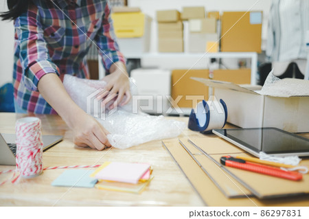 Online business owner preparing product to customer. 86297831