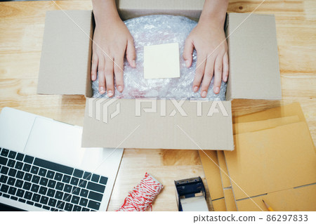 Online business owner preparing product to customer. 86297833