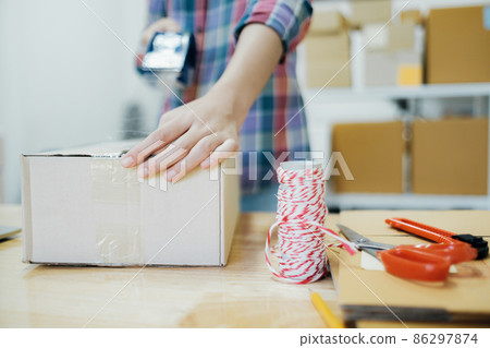 Online business owner preparing product to customer. 86297874