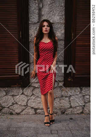 attractive brunette girl with sexy figure poses on beautiful ancient European street attractive brunette girl with sexy figure poses on beautiful ancient European street 86298452