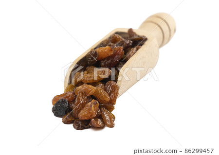 royal raisins in wooden scoop isolated on white background. Spice and food ingredients. royal raisins in wooden scoop isolated on white background. Spice and food ingredients. 86299457