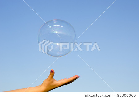 big soap bubble and girls hand big soap bubble and girls hand 86300069