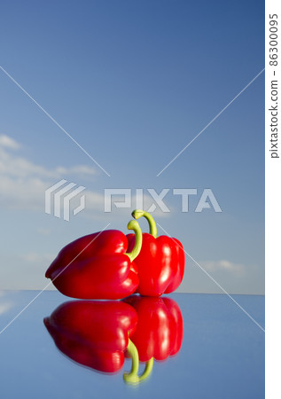 two red peppers on mirror and sky two red peppers on mirror and sky 86300095
