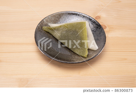 Yatsuhashi traditional kyoto sweets on black plate on woodle background. Japanese dessert 86300873