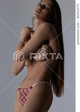 Topless woman in lingerie in studio 86302475