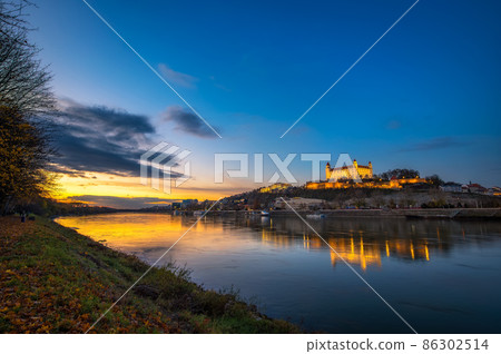 Sunset over Bratislava castle, Slovak parliament and Danube river in Slovakia Sunset over Bratislava castle, Slovak parliament and Danube river in Slovakia 86302514