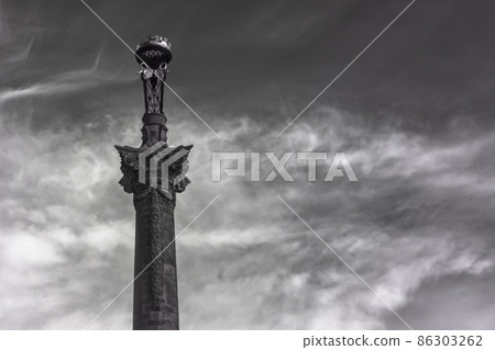 Infrared monochrome photo of ornate pillar with dramatic clouds 86303262