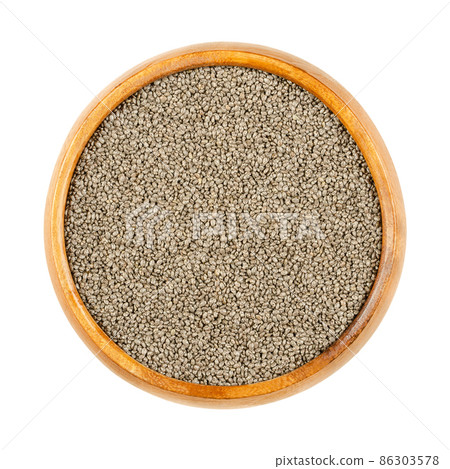 Chia seeds, in a wooden bowl. Edible seeds of Salvia hispanica, a flowering plant in the mint family (Lamiaceae). Very hygroscopic, and absorbing twelve times their weight, giving food a gel texture. 86303578