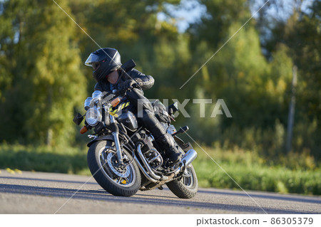 19-09-2021 Riga, Latvia A young man riding a motorcycle on an open road 86305379