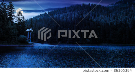 landscape with calm lake in summer at sunset. forest reflection in the water. beautiful travel background of synevyr, ukraine. green nature scene. tranquil outdoor environment in full moon light landscape with calm lake in summer at sunset. forest reflection in the water. beautiful travel background of synevyr, ukraine. green nature scene. tranquil outdoor environment in full moon light 86305394