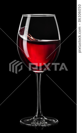 moving red wine in glass isolated on black moving red wine in glass isolated on black 86306050