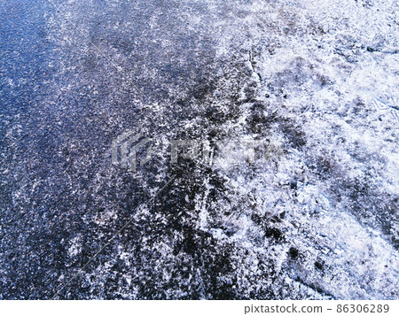 asphalt road covered with ice, slippery road winter 86306289
