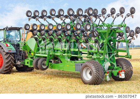 Grain seeder in transport position for compact transport of the machine as a trailed implement on a tractor. 86307047