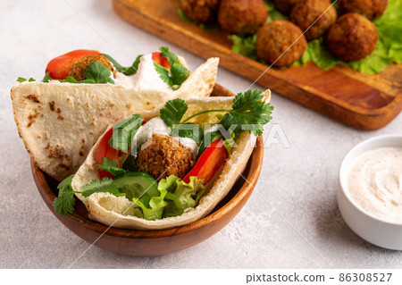Falafel and fresh vegetables in pita bread Falafel and fresh vegetables in pita bread 86308527