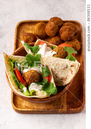 Falafel and fresh vegetables in pita bread Falafel and fresh vegetables in pita bread 86308531