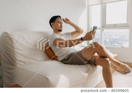 Middle age man with long eye sight try to look at the smartphone. Middle age man with long eye sight try to look at the smartphone. 86309605