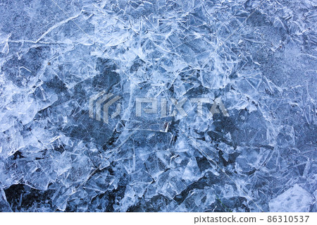 Abstract ice background. Blue background with cracks on the ice surface Abstract ice background. Blue background with cracks on the ice surface 86310537
