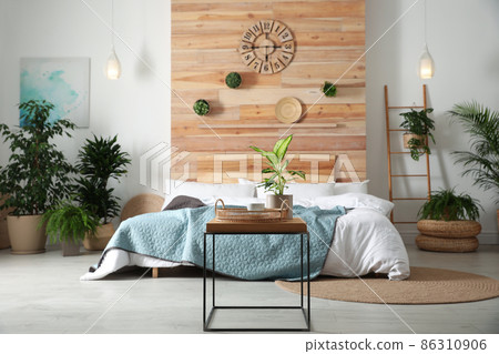 Stylish bedroom interior with green plants. Home design ideas 86310906
