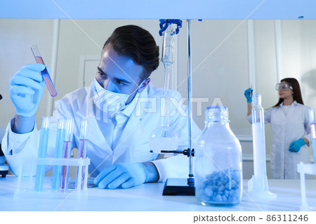 Scientist taking test tube from rack indoors. Laboratory analysis 86311246