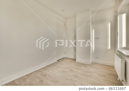 Empty room, flat with a ceiling, parquet floor, and white walls 86311697