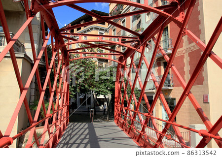 Eiffel Bridge through the river Onyar in Girona, Catalonia, Spainon on the summer sunny day. Eiffel Bridge through the river Onyar in Girona, Catalonia, Spainon on the summer sunny day. 86313542