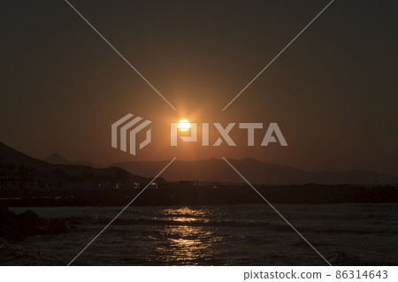 Sunset over the sea and the mountains in Kokkini Hani, Crete, Greece. Scenic seaside landscape in the evening. Sunset over the sea and the mountains in Kokkini Hani, Crete, Greece. Scenic seaside landscape in the evening. 86314643
