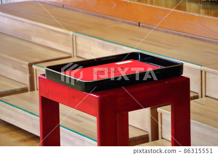 Graduation certificate in a black tray placed on a red stand Graduation certificate in a black tray placed on a red stand 86315551