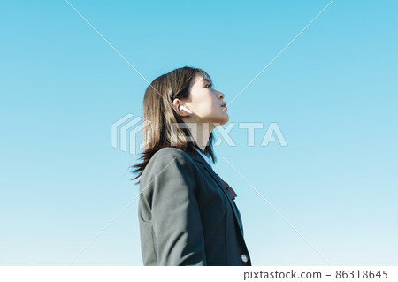 High school girl listening to music with earphones High school girl listening to music with earphones 86318645