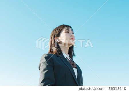 High school girl listening to music with earphones High school girl listening to music with earphones 86318648