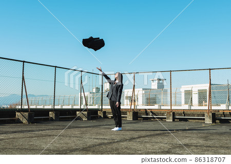 High school girl throwing a skirt on the roof of a school 86318707