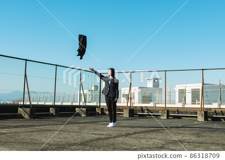 High school girl throwing a skirt on the roof of a school High school girl throwing a skirt on the roof of a school 86318709