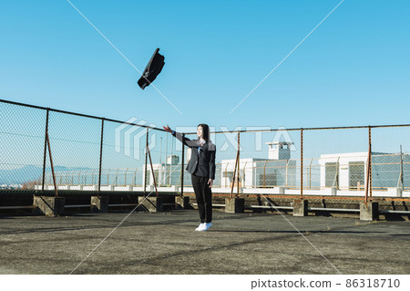 High school girl throwing a skirt on the roof of a school High school girl throwing a skirt on the roof of a school 86318710