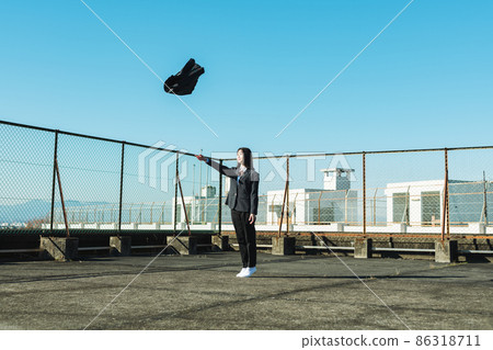 High school girl throwing a skirt on the roof of a school High school girl throwing a skirt on the roof of a school 86318711