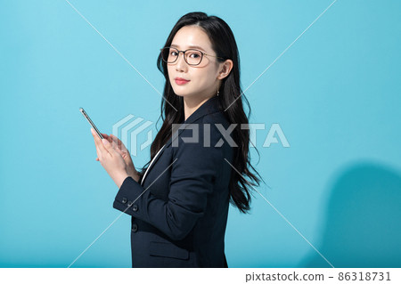 Career woman with a smartphone Career woman with a smartphone 86318731