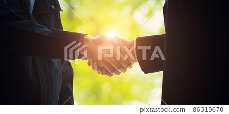 Shaking hands with green background Environmental business 86319670